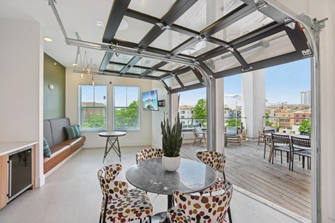 A modern dining room with a glass table and chairs.