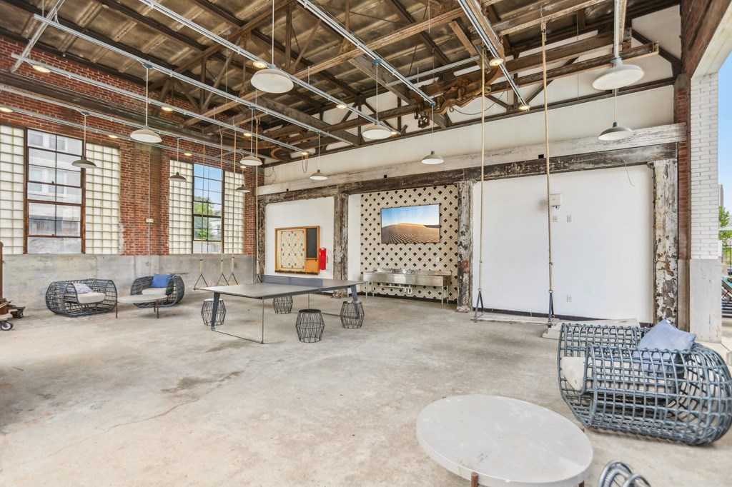 A room with a white door and a white table with a white cloth on it.
