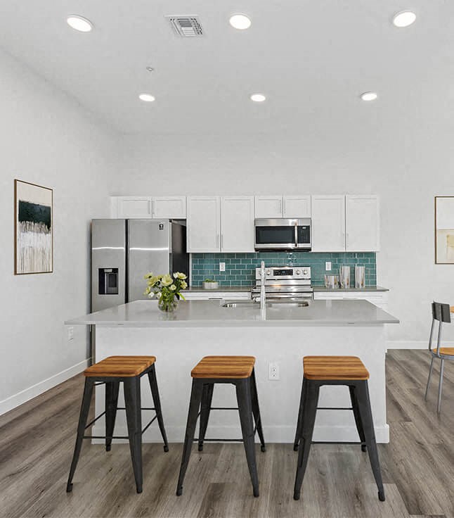 a kitchen with a counter and three stools