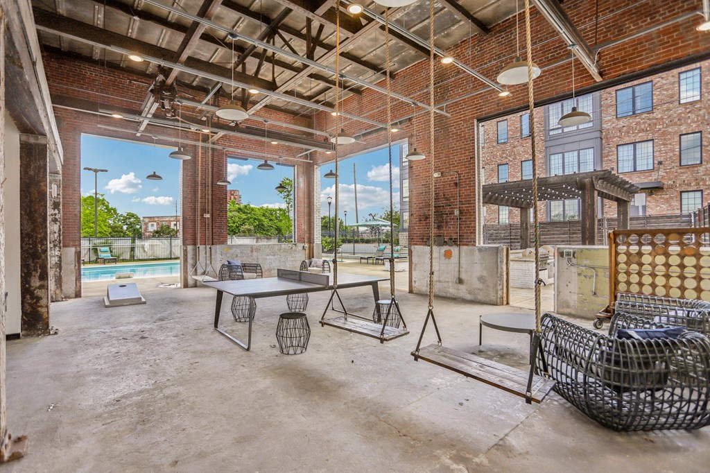 A large, empty room with a pool table and a couch.