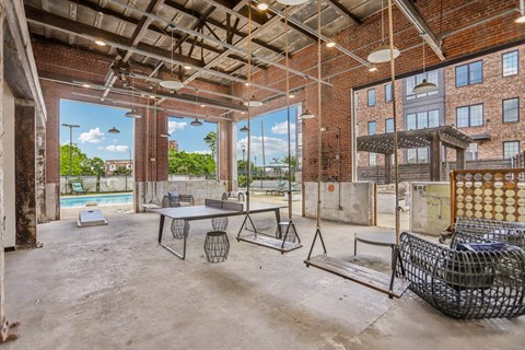 A large, empty room with a pool table and a couch.