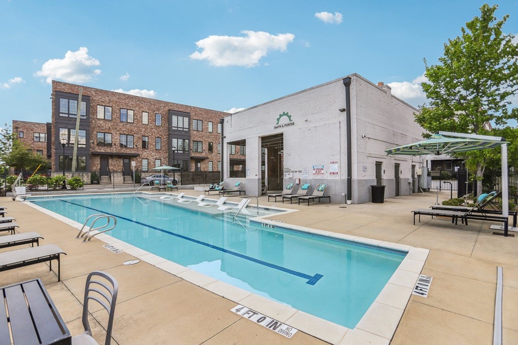 A pool area with a building in the background.