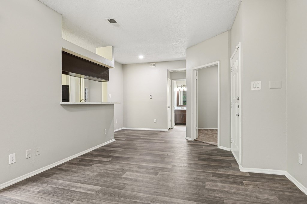 A room with a wooden floor and white walls.