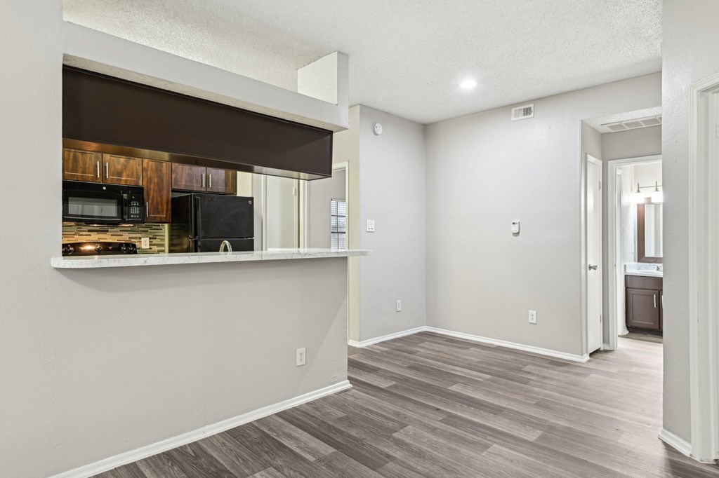 A kitchen area with a microwave and oven on the counter.