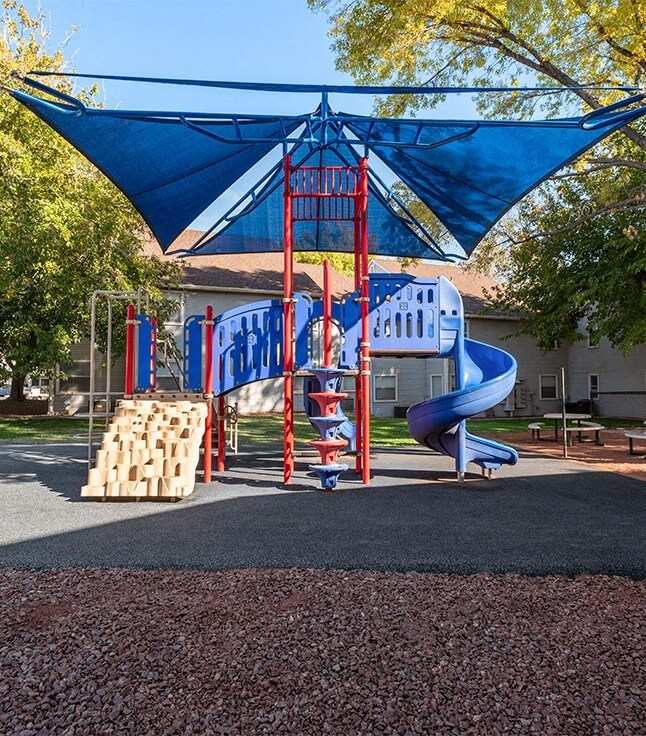 a blue and red playground with a blue slide