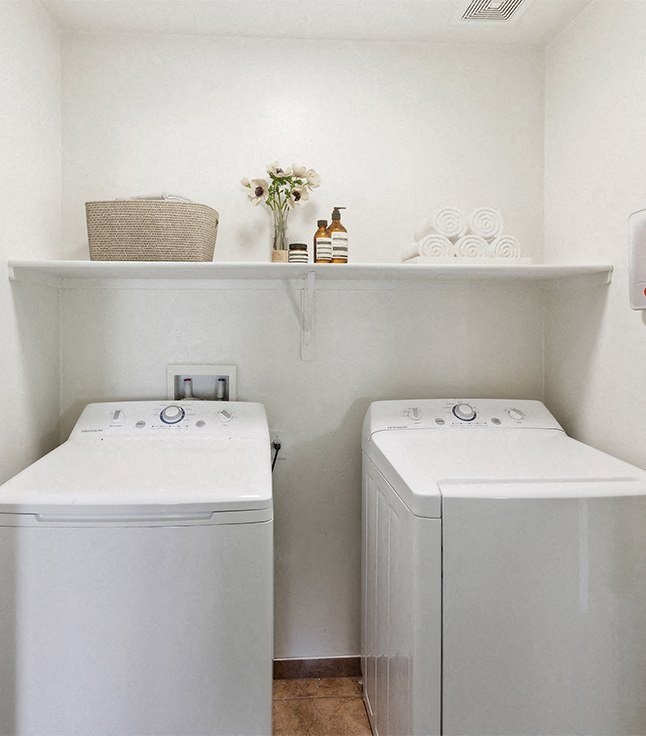 a small laundry room with two washes and a dryer at Galeria Del Rio, Tucson, Arizona