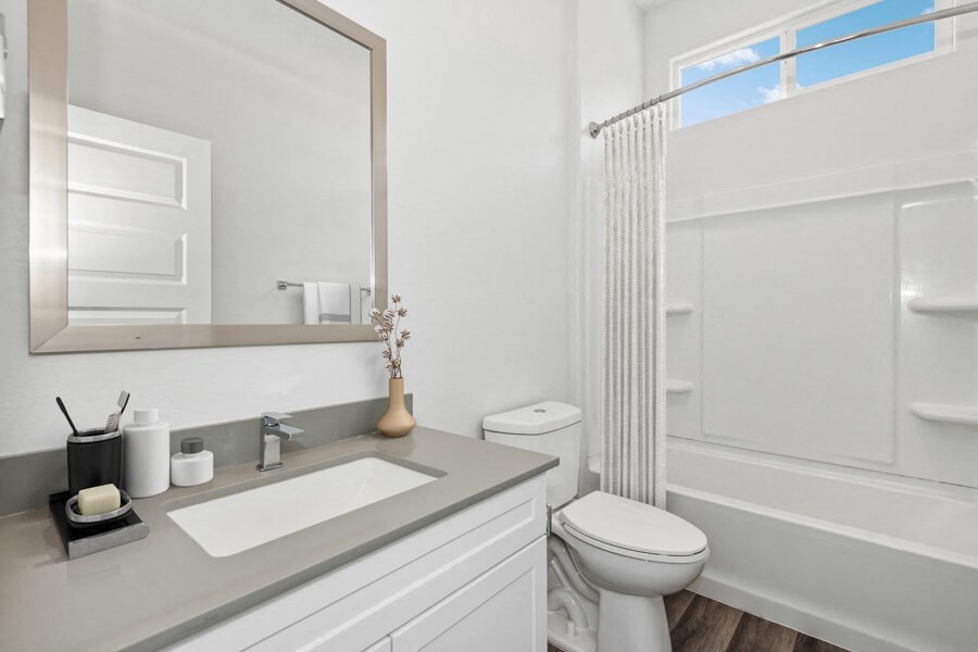 a bathroom with a sink and a toilet and a shower