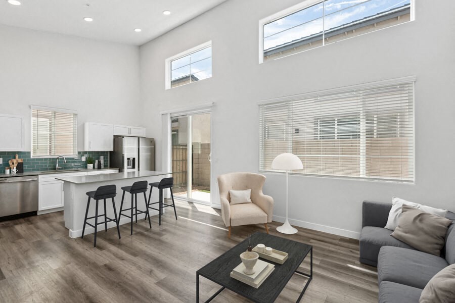 a living room with a kitchen and a couch and a table