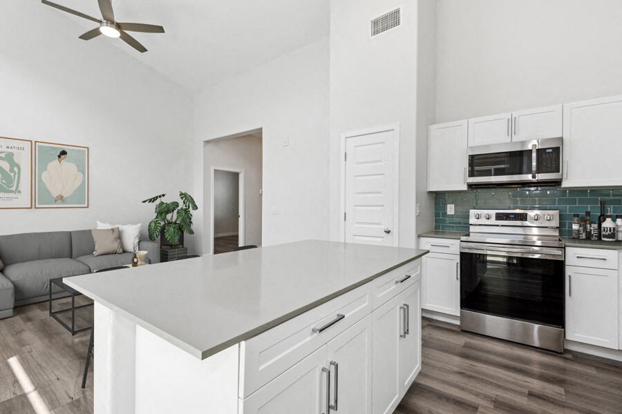 a kitchen with an island and a living room with a couch