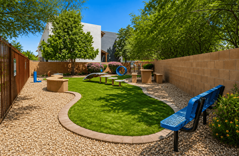 A small garden with a bench and a playground.