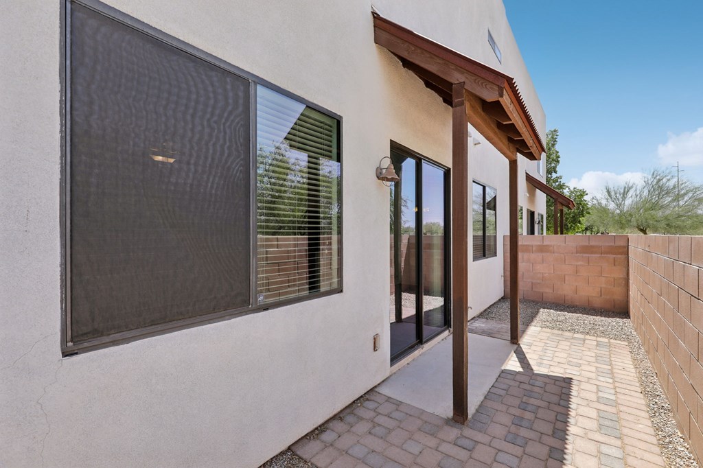 A modern house with a patio and a glass door.