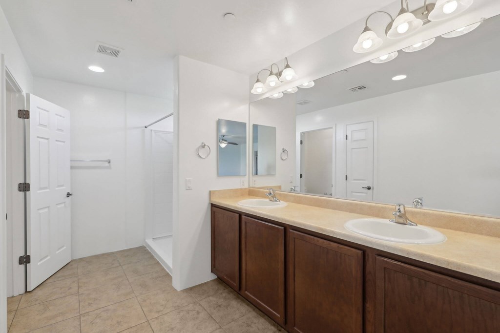 A bathroom with a vanity and a large mirror.