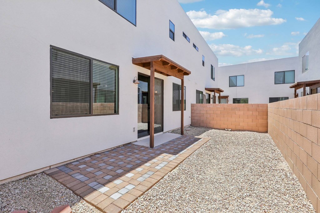 A modern house with a gravel pathway leading to the entrance.