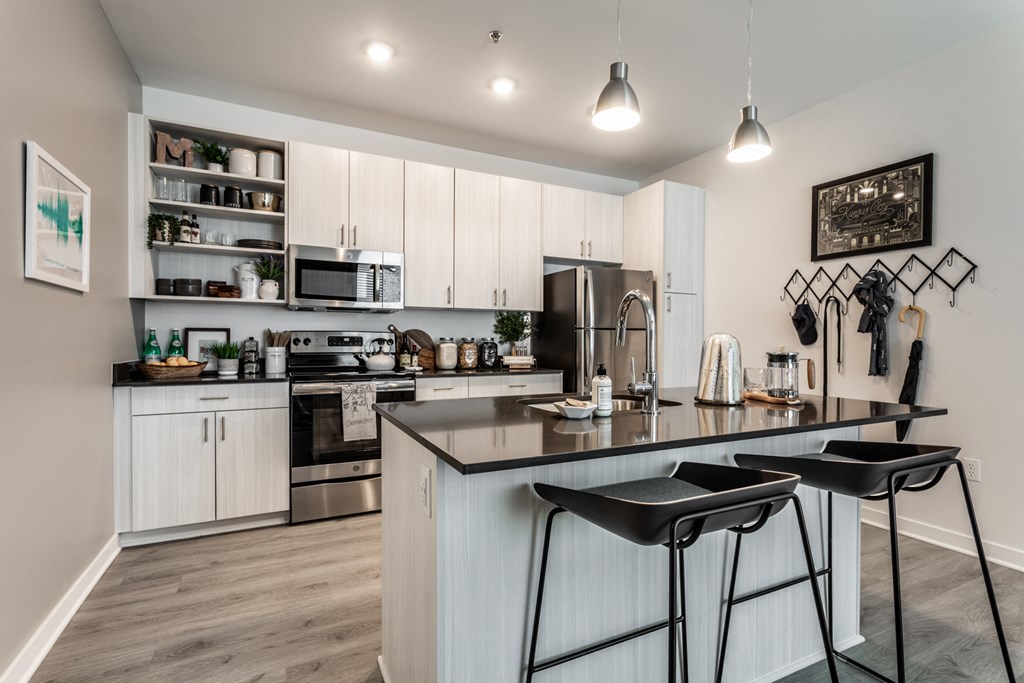an open kitchen with a large island with stools