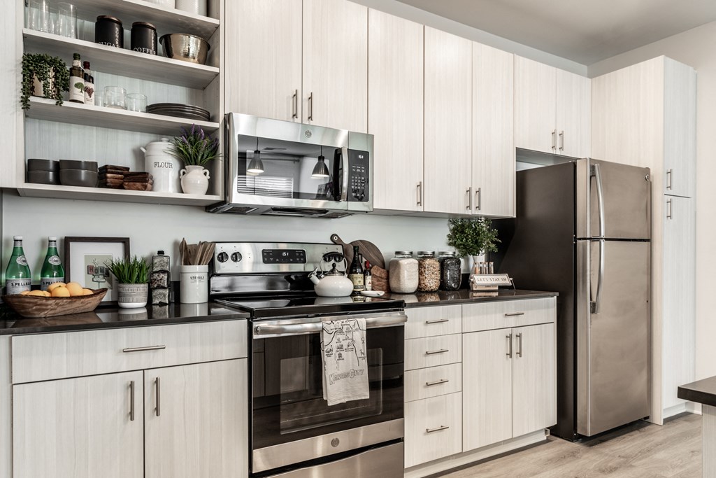 a kitchen with stainless steel appliances and white cabinets