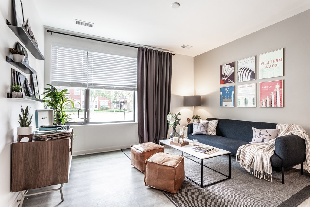 a living room with a couch and a coffee table and a window