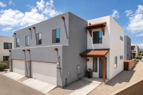 A modern house with a grey exterior and a brown roof.