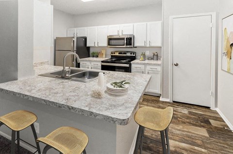 a kitchen with a marble counter top and a sink