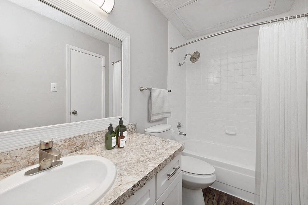 a white bathroom with a sink and a toilet at Heatherstone, Dallas