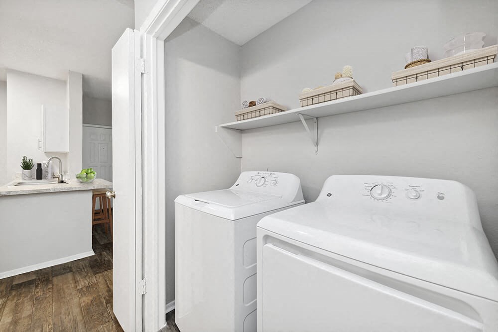 a washer and dryer in a laundry room with a sink at Heatherstone, Texas