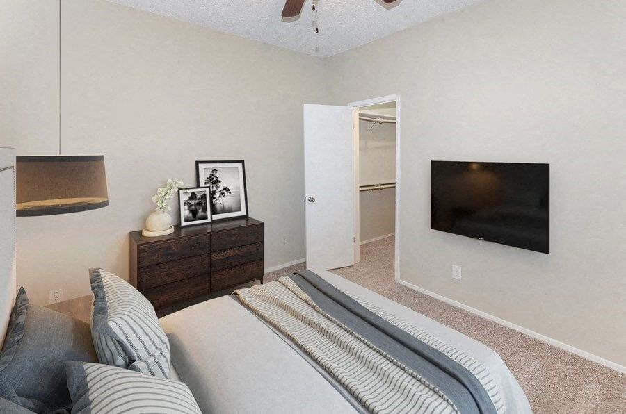 a bedroom with a bed and a television on the wall at Heatherstone, Texas, 75287