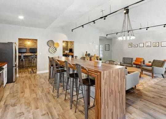 a living room with a bar and a dining table at Heatherstone, Dallas, TX, 75287