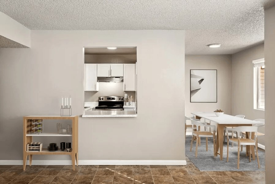 a kitchen and dining room with a white table and chairs