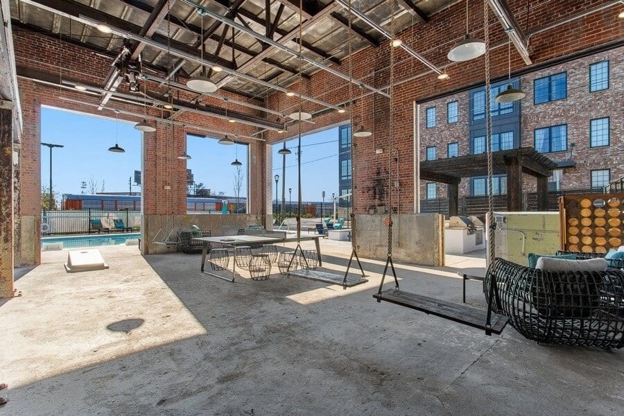 a large room with a pool and a brick building