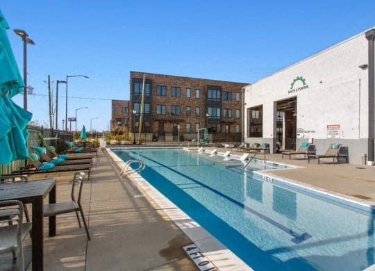 a large swimming pool in front of a building