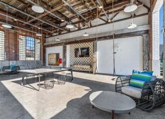 a large room with tables and chairs and a projector screen at Smith and Porter, Atlanta
