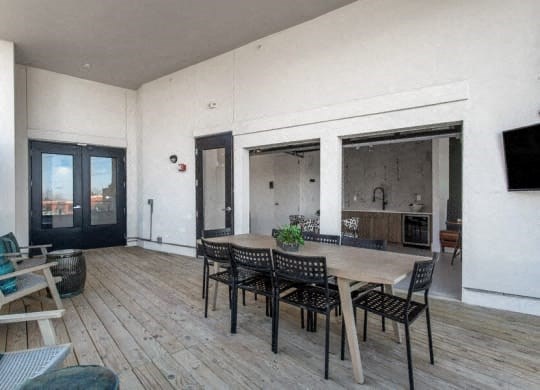 a large living room with a large wooden table and chairs