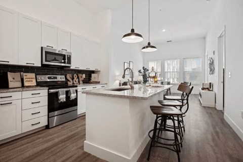 a white kitchen with a counter top and a sink