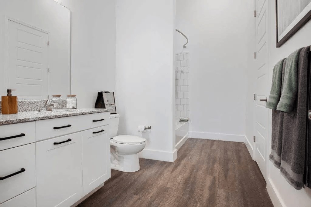 a white bathroom with a toilet and a shower at Smith and Porter, Atlanta, 30313