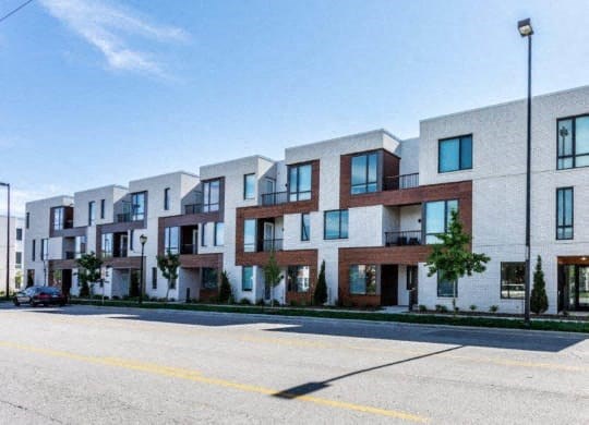 a row of apartment buildings on the side of a street at Marcato, Kansas City, 64108