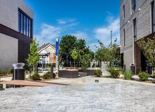 a fountain in the middle of a courtyard between two buildings at Marcato, Kansas City