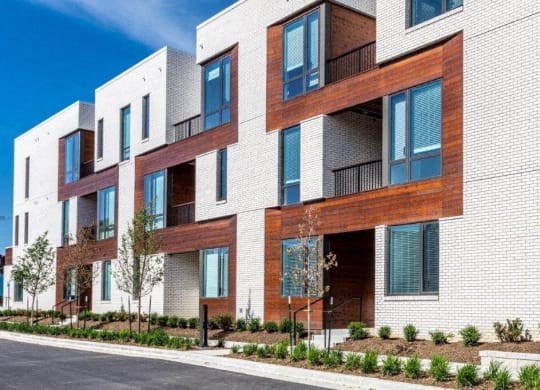 a row of modern apartment buildings on a street at Marcato, Kansas City