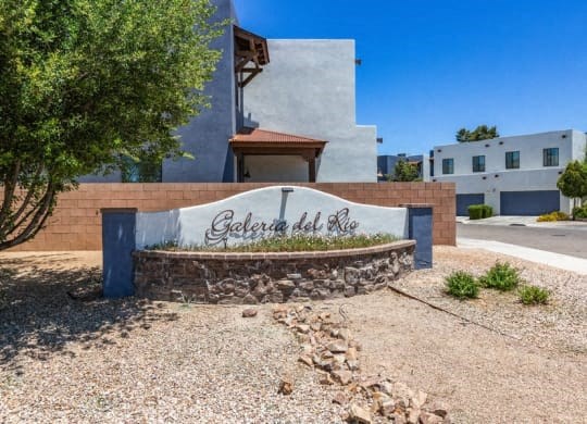 a sign with the name of a building in the middle of a street