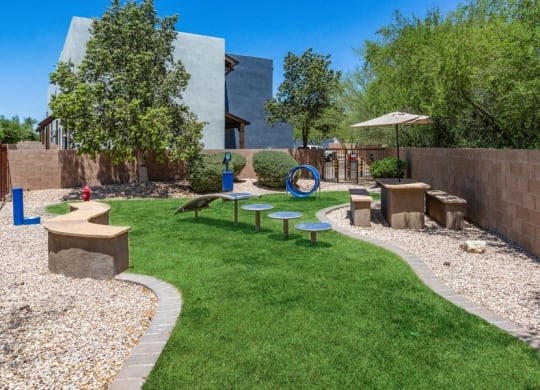 the backyard has a playground and a picnic area with benchesat Galeria Del Rio, Arizona, 85704