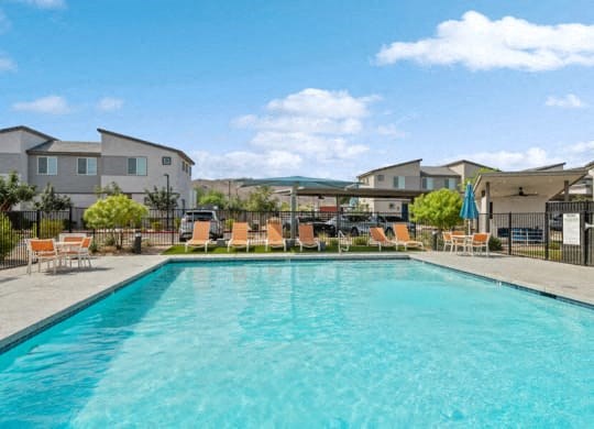 a large swimming pool with chairs around it
