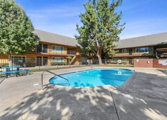 a swimming pool with a building in the background
