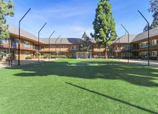 a soccer field in front of an apartment building