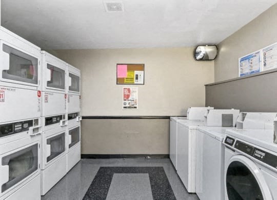 a laundry room with a bunch of washes and dryers
