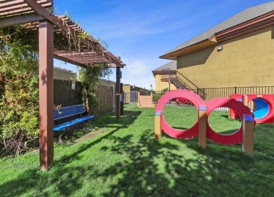 the backyard of a house with a playground and