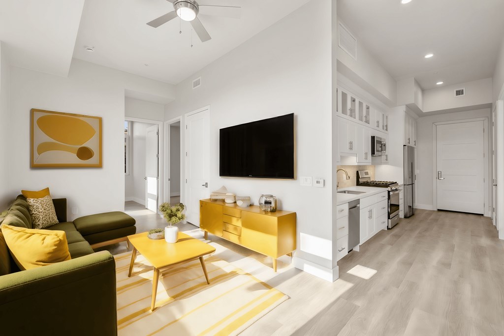 a living room with a couch and a yellow table