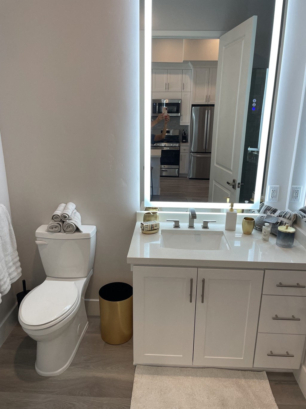 a bathroom with a toilet and a sink and a mirror