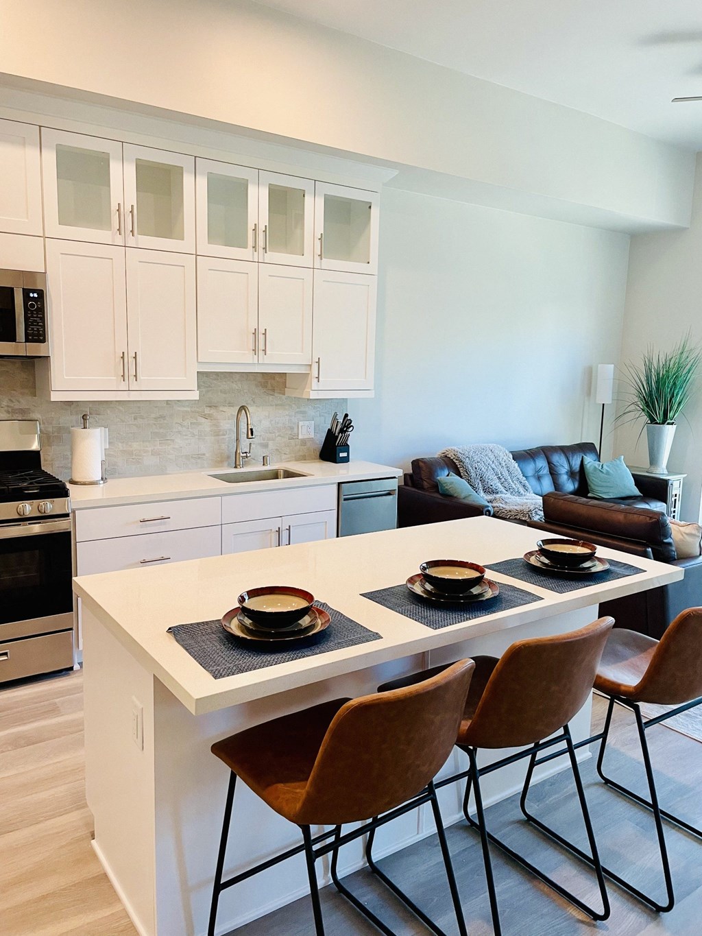 a kitchen and living room with a table and chairs