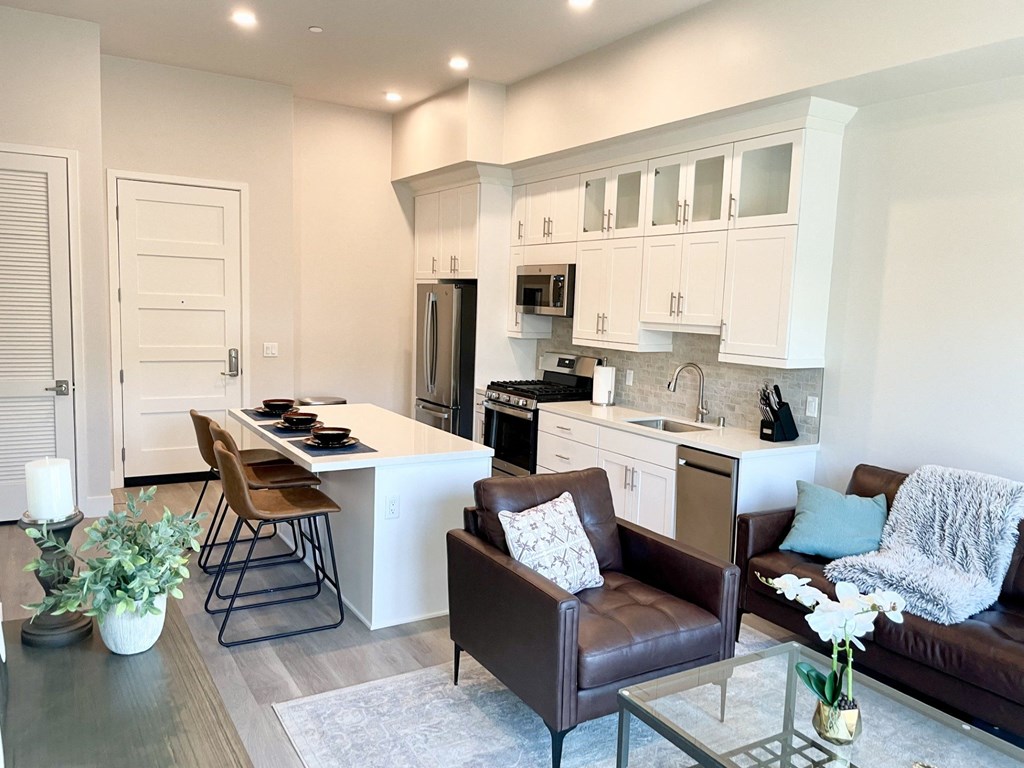 a kitchen and living room with a table and chairs