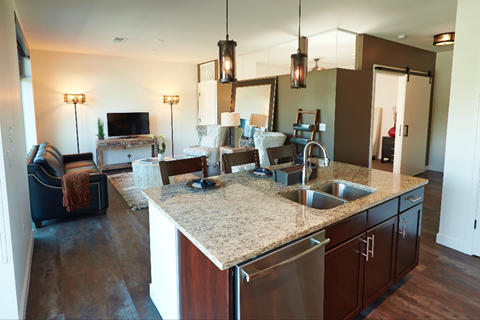 A kitchen with a sink and a counter.