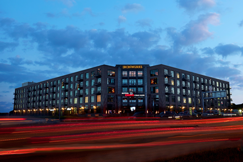A long exposure shot of a building with the name "IRONWORKS" on it.