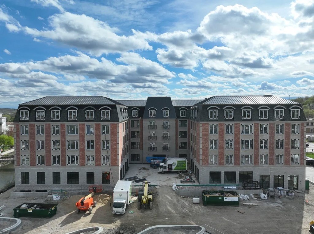 an aerial view of a large building with trucks in front of it